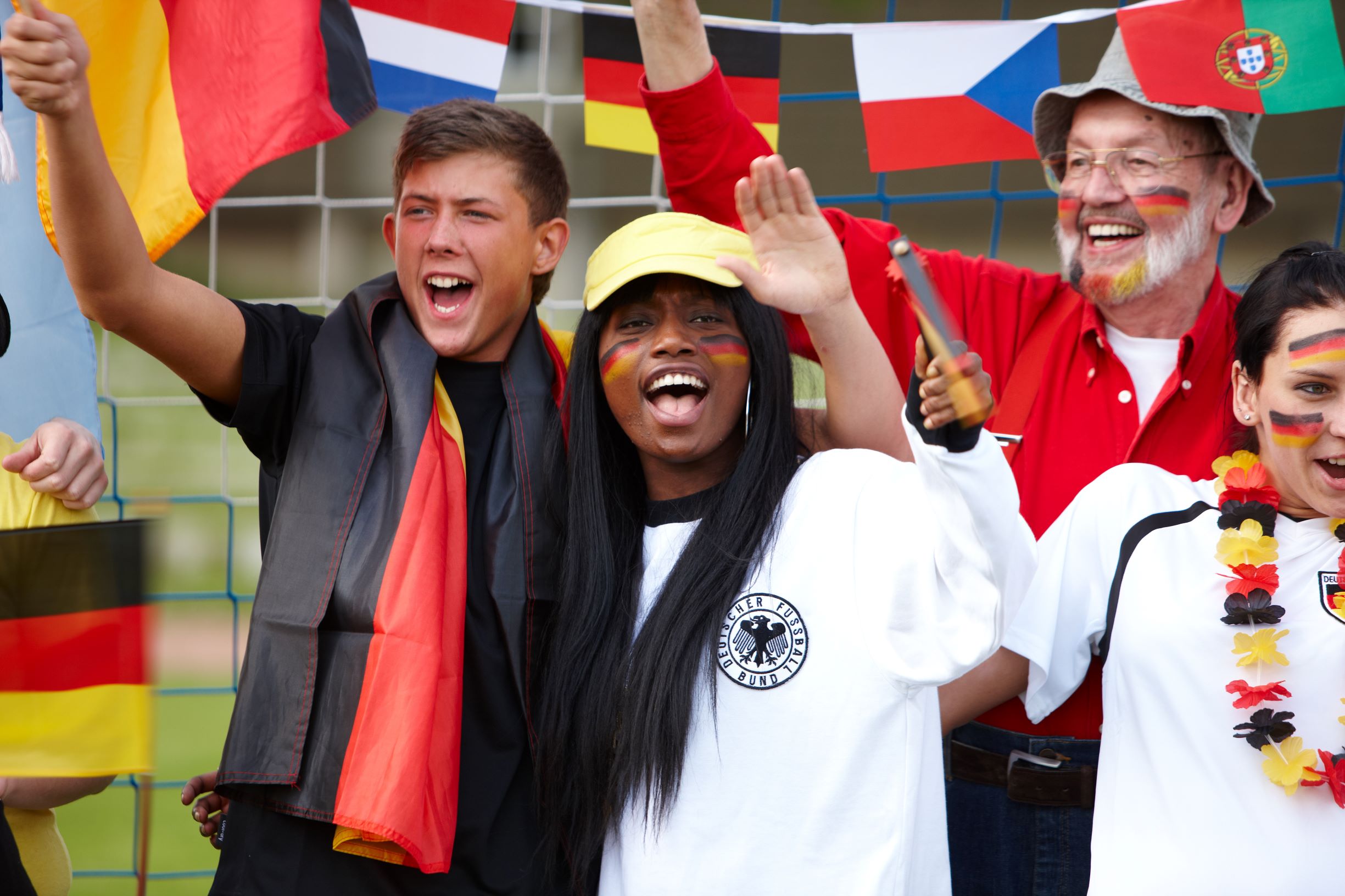 Cheering soccer fans in the stadium international flags