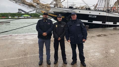 A Spanish policeman, an Italian policeman and Richard Braun in front of a sailing ship